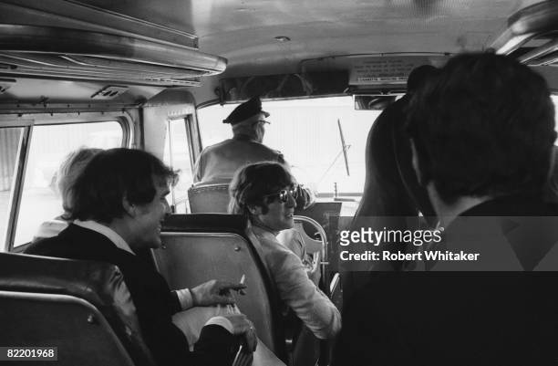 Road manager Neil Aspinall and John Lennon take a bus with the Beatles to the Westwood Hotel in Anchorage, Alaska, 27th-28th June 1966. En route for...
