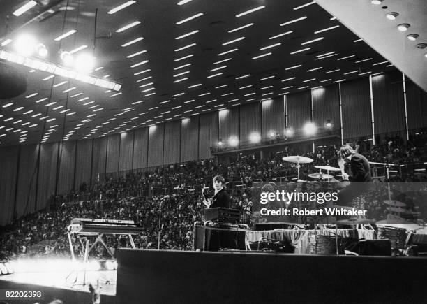 The Beatles play their second, evening, concert at the Grugahalle in Essen during the German leg of their final world tour, 25th June 1966. Left to...