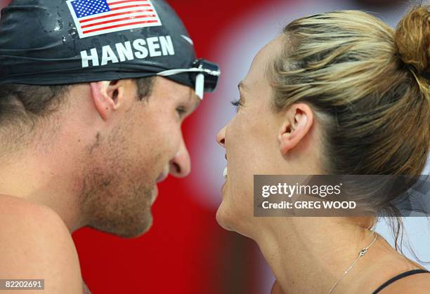 Amanda Beard of the US talks with her team mate Brendan Hansen as they prepare for a training session at the National Aquatics Center, also known as...