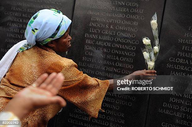 Mary Loko Muthike, a survivor of a deadly bombing of the US embassy in 1998, places a flower on August 7, 2008 at a memorial wall that was erected on...