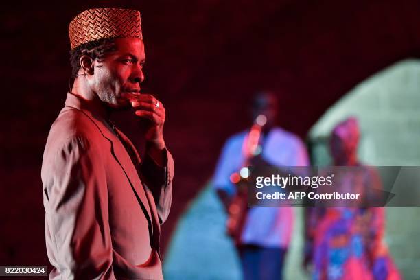 Ivorian actor Isaac de Bankole performs with Cameroonian-French saxophonist Manu Dibango and Beninese singer Angelique Kidjo during a rehearsal of...
