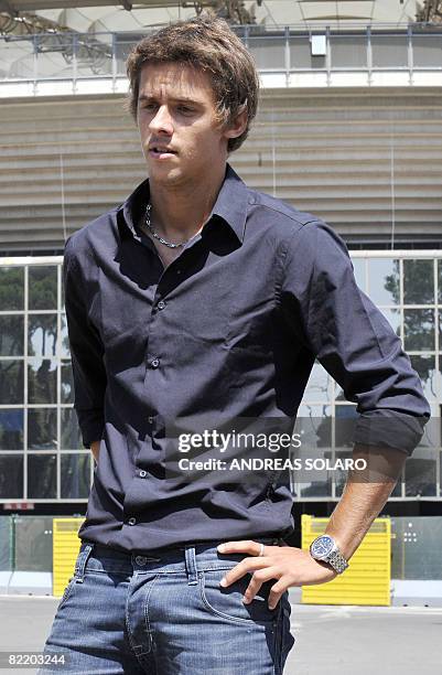 Italy's world number one foil fencer Andrea Baldini poses for photographers as he leaves the Olympic Committee headquarters after he was interviewed...