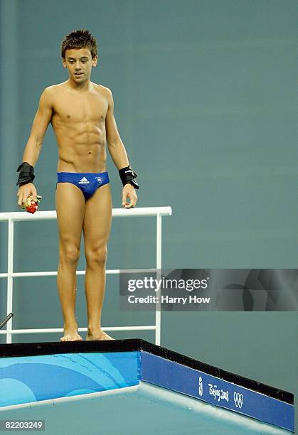 Thomas Daley of Great Britain receives instruction as he stands on the 10m platform ahead of the Beijing 2008 Olympic Games at the National Aquatics...