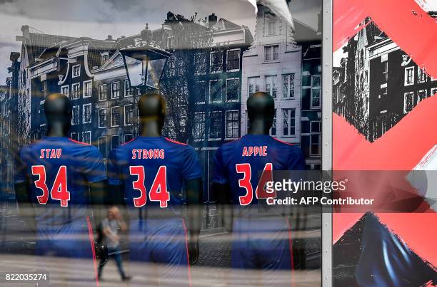 This picture shows puppets in a fanshop wearing shirts with the number 34 of Ajax midfielder Abdelhak Nouri reading "Stay strong Appie" in Amsterdam...