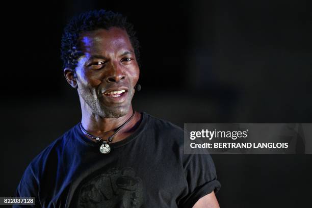 Ivorian actor Isaac de Bankole performs during a rehearsal of 'Femme Noire' on July 24, 2017 at the "Cour d'Honneur du Palais des Papes" in Avignon,...