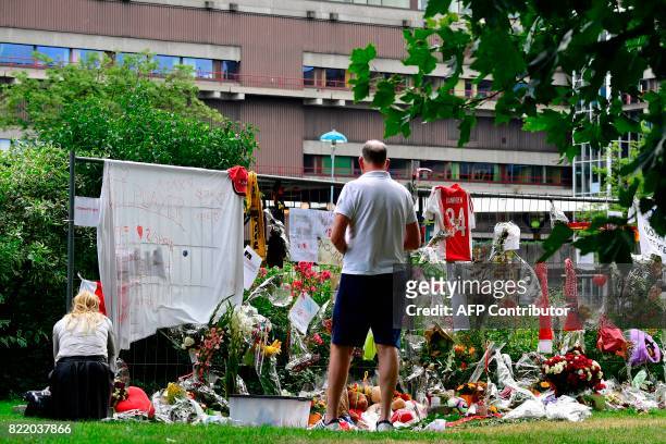 Visitors stand next to items placed by the hospital where the Ajax midfielder Abdelhak Nouri receives treatments in Amsterdam on July 22, 2017. Ajax...