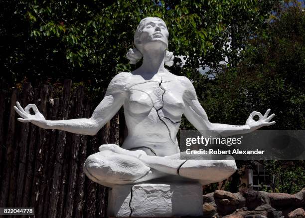 Sculpture of a woman in the yoga lotus pose by Paige Bradley is among the artworks for sale in galleries along Canyon Road in Santa Fe, New Mexico.