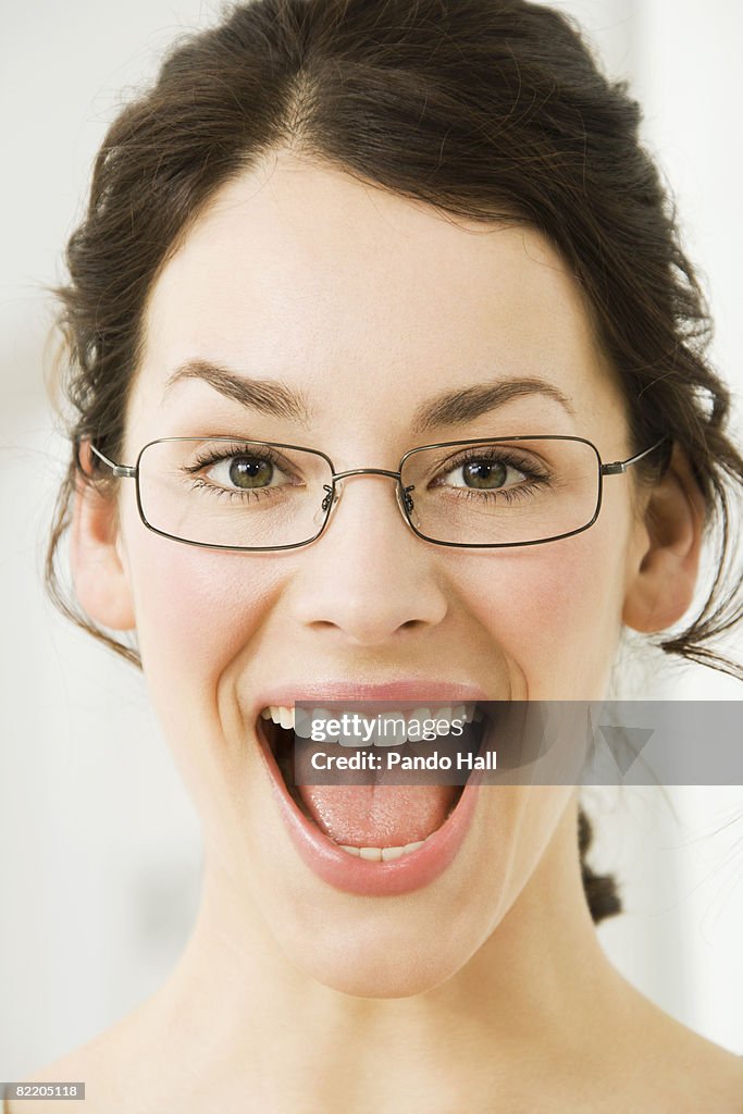 Young woman laughing, mouth wide open