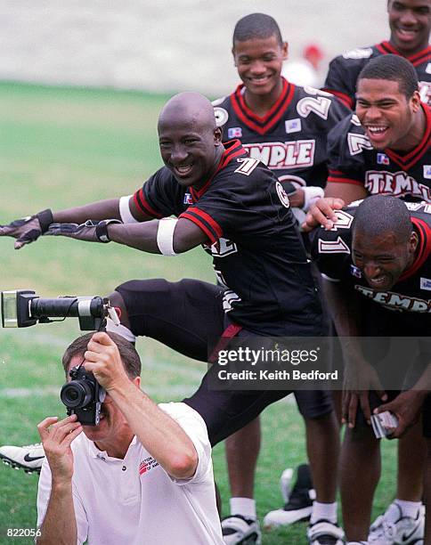 Temple University's Carlos Johnson tries to make his teammates laugh during team photo sessions, Tuesday, August 24, 1999 during media day at the...