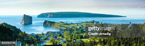 panorama of perce rock in quebec, canada with pine trees in the foreground, and blue waters of the gulf of st. lawrence - gaspe peninsula stock pictures, royalty-free photos & images