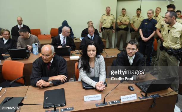 Beate Zschaepe, the main defendant in the marathon NSU neo-Nazi murder trial sits inbetween her lawyers Hermann Borchert and Mathias Grasel in court...