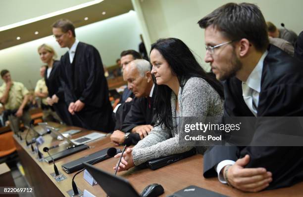 Beate Zschaepe, the main defendant in the marathon NSU neo-Nazi murder trial sits inbetween her lawyers Hermann Borchert and Mathias Grasel in court...