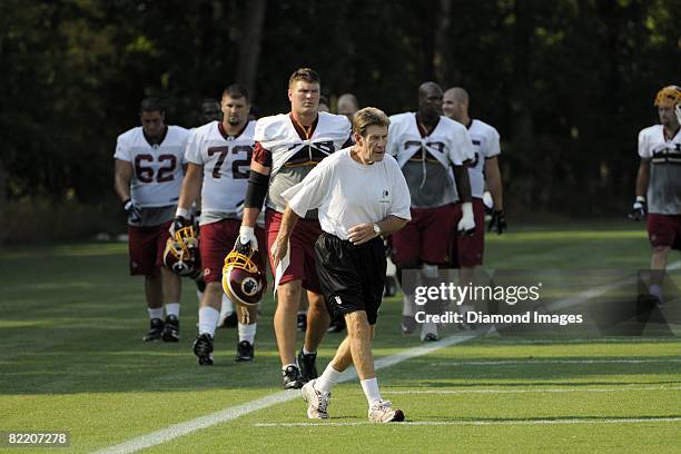 Offensive line coach Joe Bugel leads his linemen, including Devin Clark, Andrew Crummey and Jon Jansen to the next drill location during training...