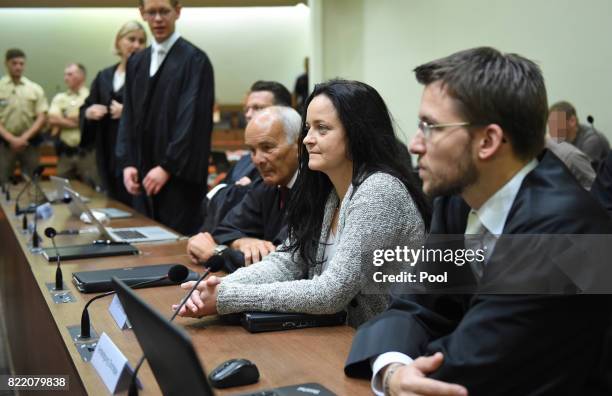 Beate Zschaepe, the main defendant in the marathon NSU neo-Nazi murder trial sits inbetween her lawyers Hermann Borchert and Mathias Grasel in court...