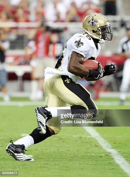 Reggie Bush of the New Orleans Saints carries the ball against the Arizona Cardinals in a pre-season game at University of Phoenix Stadium August 7,...