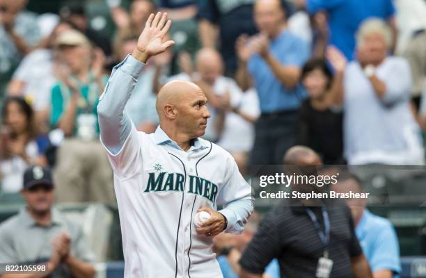 Former Seattle Mariners player Raul Ibanez waves to the crowd before throwing out the ceremonial first pitch before a game between the New York...