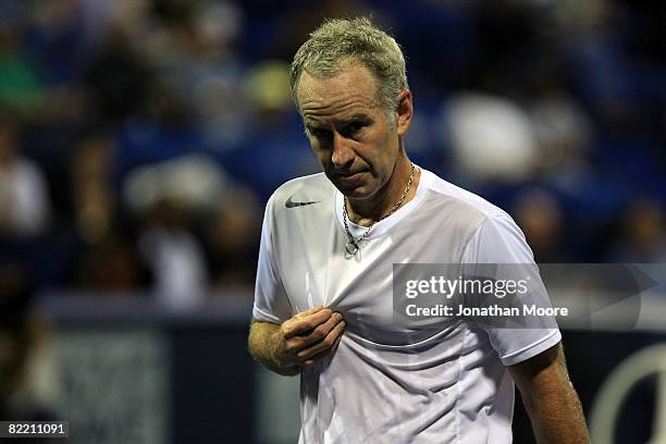 John McEnroe looks on during a pause in action against Mikael Pernfors of Sweden during day four of the Countrywide Classic at the Los Angeles Tennis...