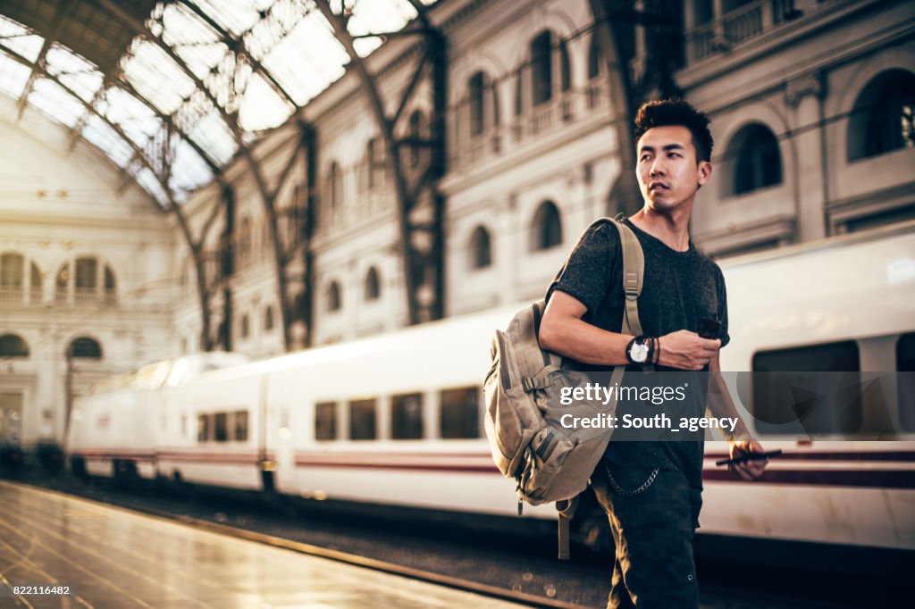 Chinese hipster man on a station