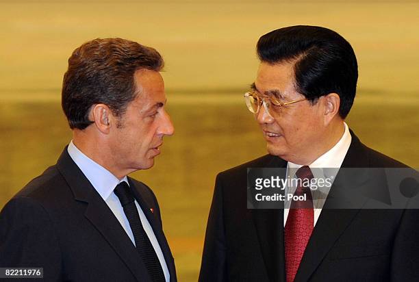 French President Nicolas Sarkozy chats with Chinese President Hu Jintao before a welcome banquet at the Great Hall of People on August 8, 2008 in...
