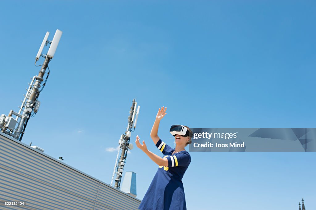 Young woman wearing VR Glasses at rooftop