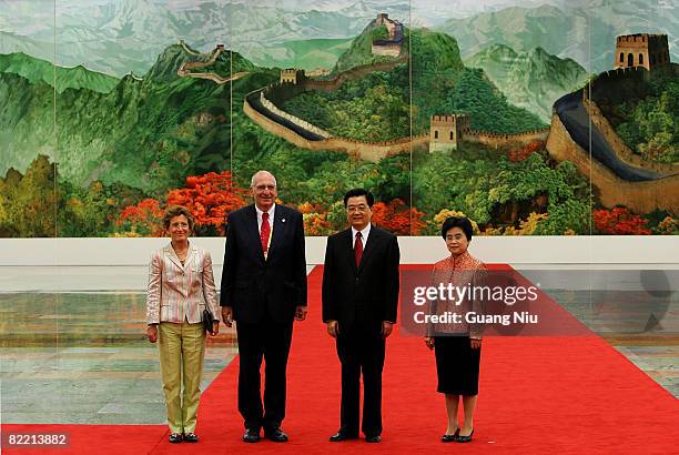 Swiss President Pascal Couchepin and his wife pose for a photo with Chinese President Hu Jintao and his wife Liu Yongqing before a welcome banquet at...