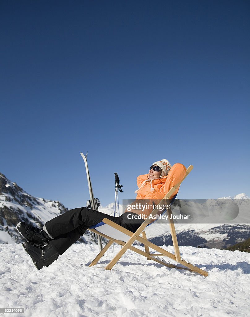 Woman (40-45) relaxing in snowy landscape