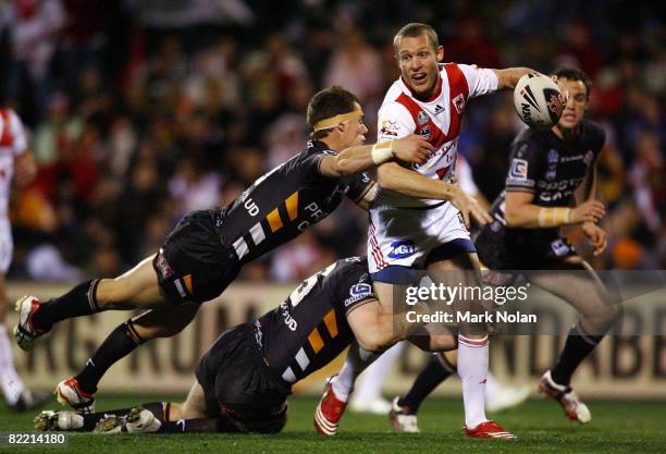 Ben Hornby of the Dragons looks for support as he is tackled during the round 22 NRL match between the St George-Illawarra Dragons and the Wests...