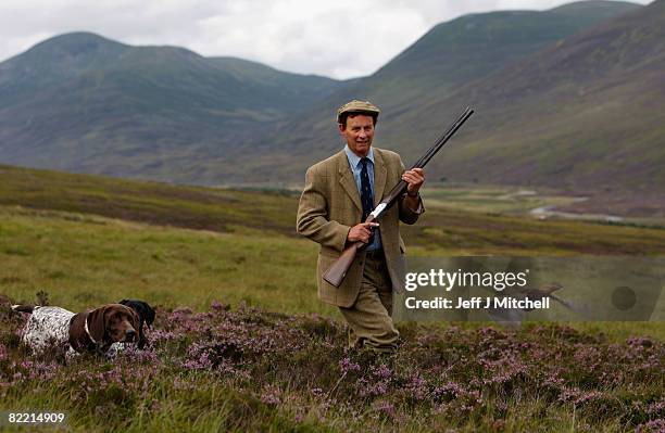 Ian McColl, director of the Game and Conservation Trust, watches a grouse on the Railia and Milton Estate near Dalwhinnie August 8, 2008 in Scotland....