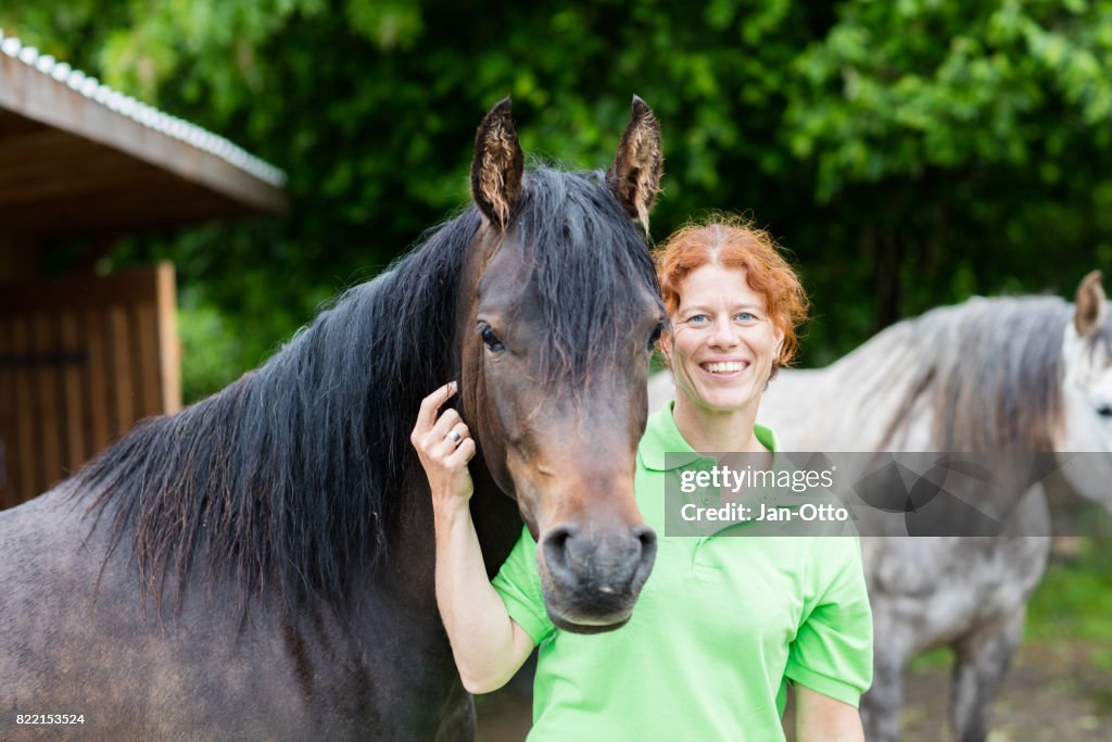Veterinarian smiling with horses