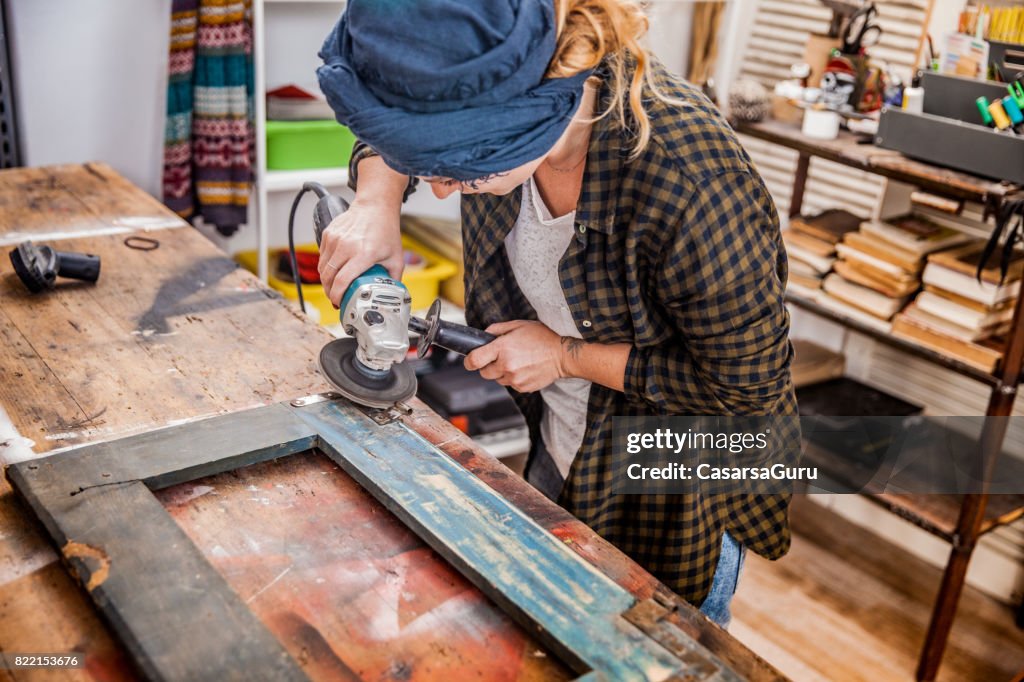 Creative Young Woman Restoring the Vintage Frame