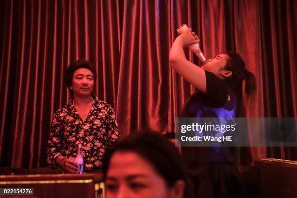 Tibetan drink beer in Tibetan Bar on July 22 ,2017 in Litang County, southwest of Garze Tibetan Autonomous Prefecture, Sichuan, China. Litang Town is...