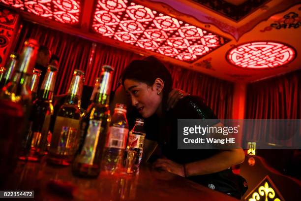 Tibetan bar girl talks to a guest in Tibetan Bar on July 22 ,2017 in Litang County, southwest of Garze Tibetan Autonomous Prefecture, Sichuan, China....