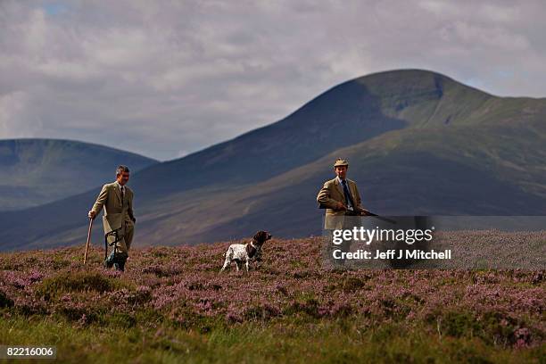 Ian McColl, director of the Game and Conservation Trust and gamekeeper Alastaitr Lyon watch for grouse on the Railia and Milton Estate on Drumochter...