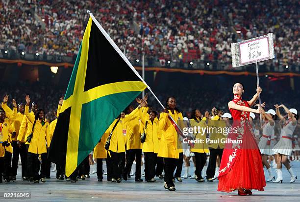 Runner Veronica Campbell of Jamaica carries her country's flag to lead out the delegation during the Opening Ceremony for the 2008 Beijing Summer...