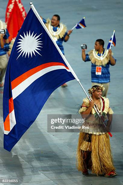 Waylon Muller of the Marshall Islands carries his country's flag during the Opening Ceremony for the 2008 Beijing Summer Olympics at the National...