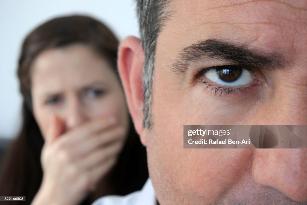 Shocked wife looks her a husband in disbelief