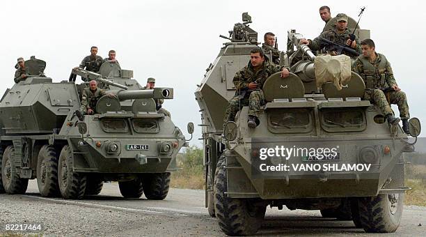 Georgian troops ride on mobile artillery during armed conflict with South Ossetian separatists, in the town of Gori on August 8, 2008. South Ossetian...