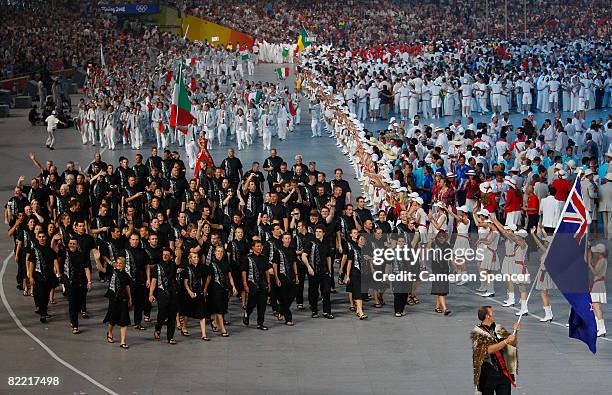 Mahe Drysdale of the New Zealand Olympic rowing team carries his country's flag to lead out the delegation during the Opening Ceremony for the 2008...