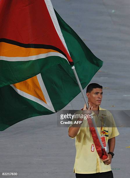 Niall Roberts Guyana's flag bearer parades in front of his delegation during the 2008 Beijing Olympic Games opening ceremony on August 8, 2008 at the...
