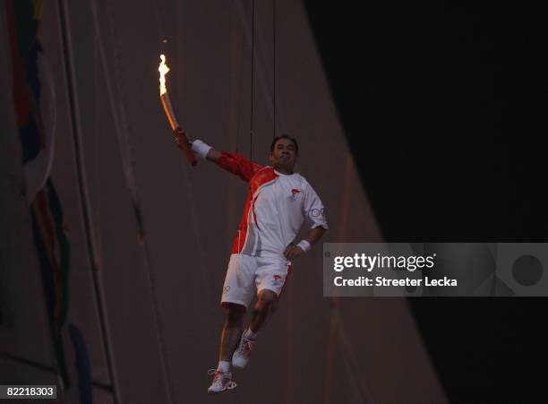 Gymnast Li Ning is lifted with the torch to light the Olympic Flame during the Opening Ceremony for the 2008 Beijing Summer Olympics at the National...