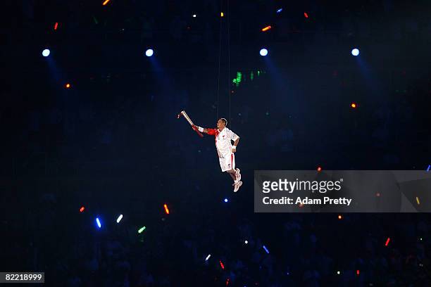 Gymnast Li Ning carries the Olympic Torch during the Opening Ceremony for the 2008 Beijing Summer Olympics at the National Stadium on August 8, 2008...