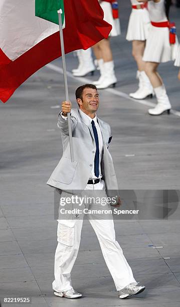 Antonio Rossi of the Italy Olympic canoe/kayak team carries his country's flag to lead out the delegation during the Opening Ceremony for the 2008...