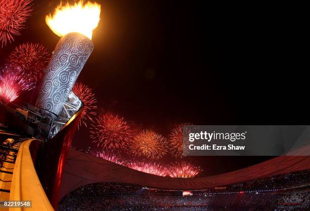 Fireworks go off after the torch is lit during the Opening Ceremony for the 2008 Beijing Summer Olympics at the National Stadium on August 8, 2008 in...