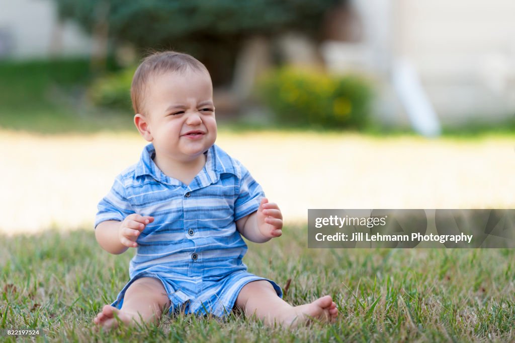 12 Month Old Baby Makes a Funny Face and While Showing His Muscles