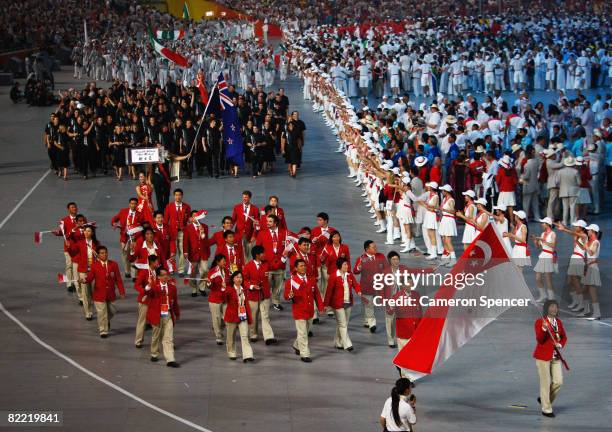 Jiawei Li of the Olympic table tennis team carries her country's flag to lead out the delegation during the Opening Ceremony for the 2008 Beijing...