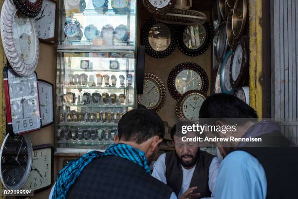 Man sells watches and clocks in a bazaar in Kabul's old city neighborhood on July 20, 2017 in Kabul, Afghanistan. Despite a heavy security presence...