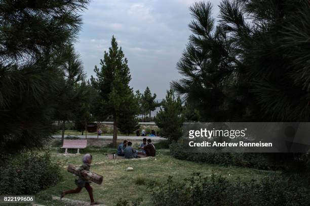 People gather in a park on the top of Wazir Hill on July 19, 2017 in Kabul, Afghanistan. Despite a heavy security presence throughout the city, life...
