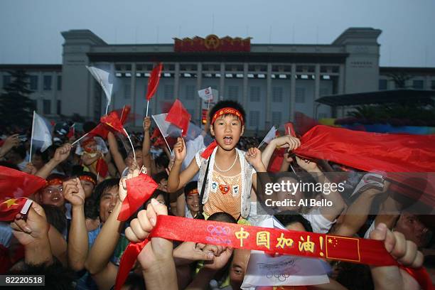 People cheer outside The National Musem of China at Tiananmen Square during the Opening Ceremony for the 2008 Beijing Summer Olympics at Tiananmen...