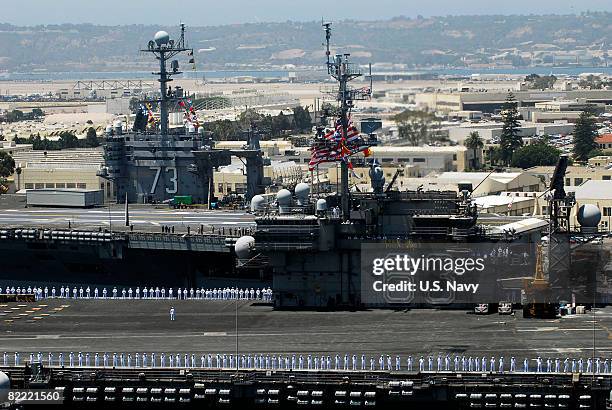 In this handout provided by the U.S. Navy, the aircraft carrier USS Kitty Hawk sails past the nuclear-powered aircraft carrier USS George Washington...