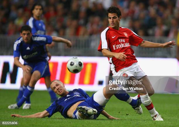 Rasmus Lindgren of AFC Ajax tries to tackle Cesc Fabregas of Arsenal during the Amsterdam Tournament match between Ajax and Arsenal at the Amsterdam...
